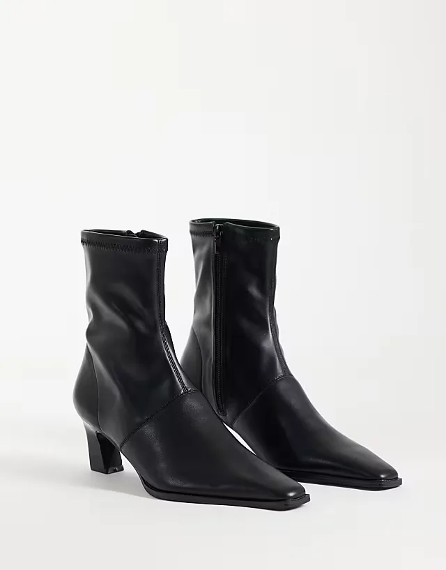 Rudy chisel toe heeled sock boots in black
