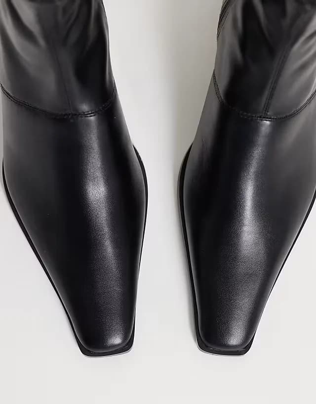 Rudy chisel toe heeled sock boots in black