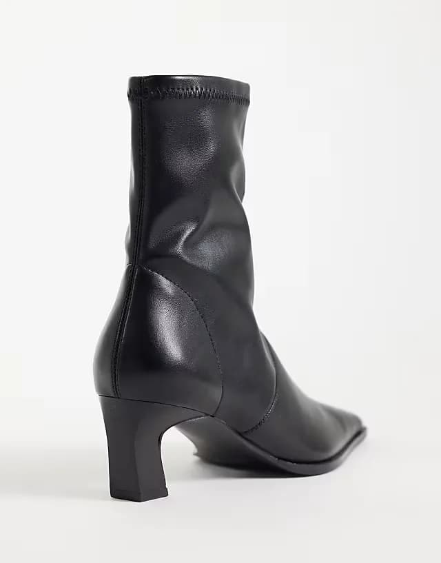 Rudy chisel toe heeled sock boots in black